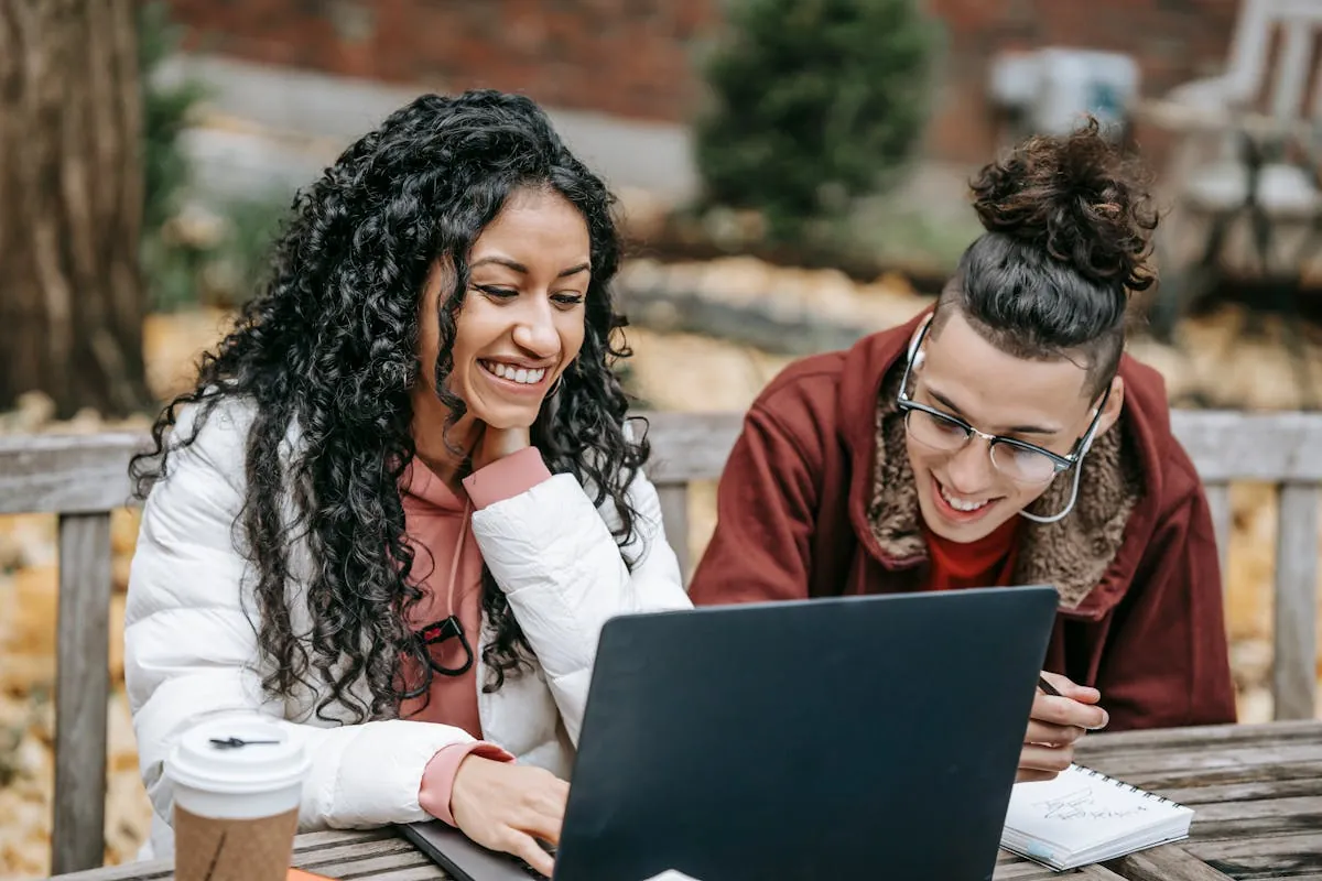 Happy students learning together on a laptop